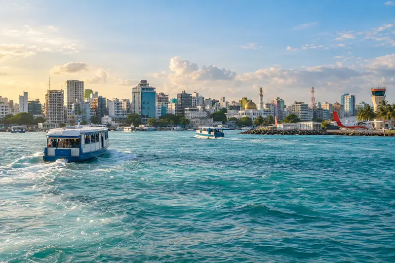 Male city waterfront with ferry traffic in the Maldives
