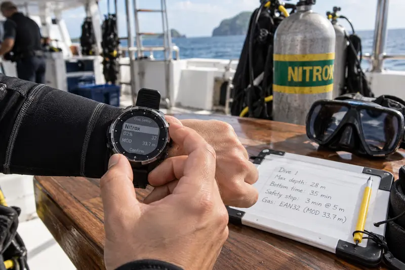 Diver setting a Nitrox-compatible dive computer before a liveaboard dive